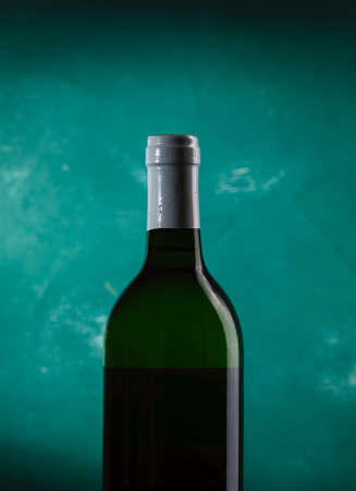 Bottle of white wine on a green backgroundの写真素材