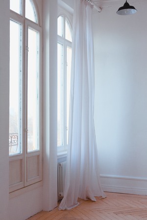 large Windows with curtains in white loft interior. vertical imageの写真素材