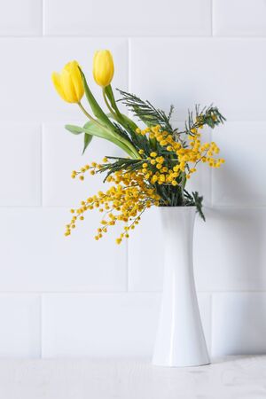Home decor, mimosa yellow spring flowers and tulipsの写真素材