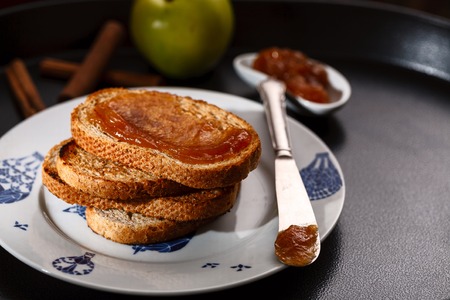 toasts with apple jam on black metallic trayの写真素材