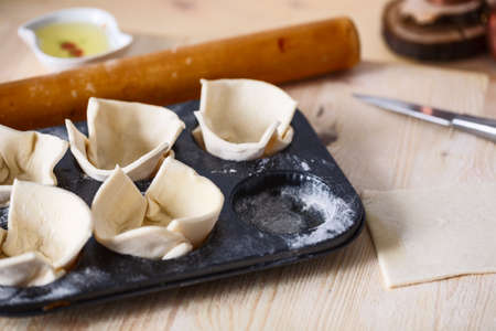 raw dough in a baking dish. Closeup. Top view. On wooden table. Copyspaceの写真素材