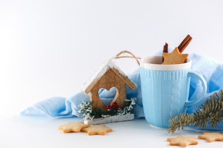 blue mug and ginger cookies on white background. Christmas compositionの写真素材