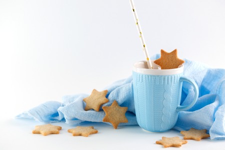 blue mug and ginger cookies on white background. Christmas compositionの写真素材