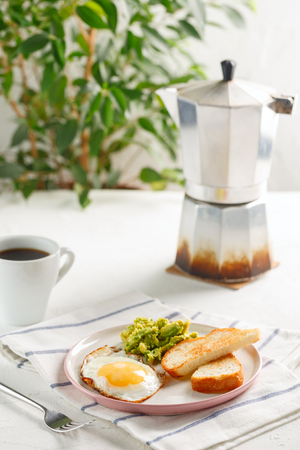 healthy breakfast. egg, avocado and toasts with coffee on white backgroundの写真素材