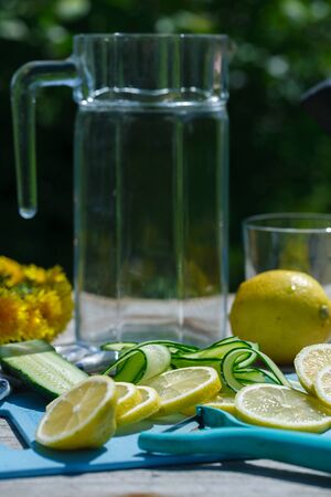 preparation of refreshing summer detox lemonade from cucumber, lemon and mintの写真素材