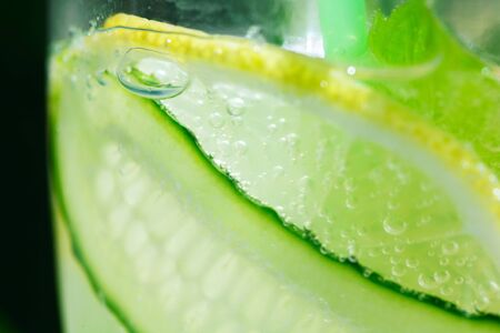 Summer refreshing drink. detox lemonade from cucumber, lemon and mint. Closeupの写真素材