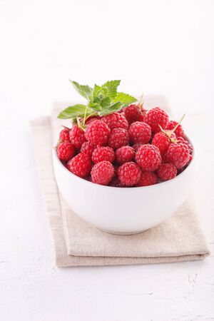 fresh raspberries with mint in a white Cup