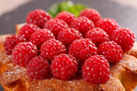 raspberry cake on a black plateの写真素材