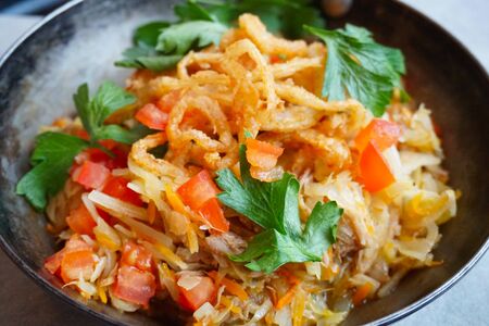 braised cabbage with tomato, onion fries and herbs. Closeupの写真素材