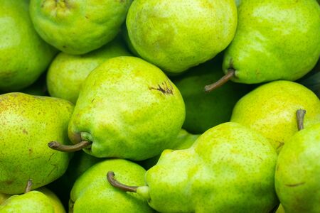 Green pears background on the market. closeupの写真素材