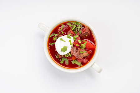 Business lunch. Traditional borscht with beef and sour cream in a white bowl on a white backgroundの写真素材