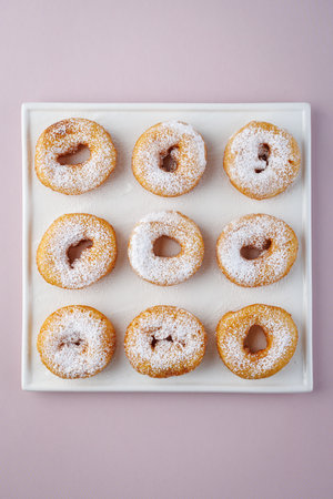 powdered donuts on a white plateの写真素材