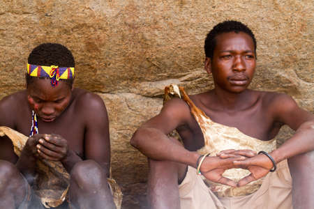 hadzabe boys sitting under rockのeditorial素材