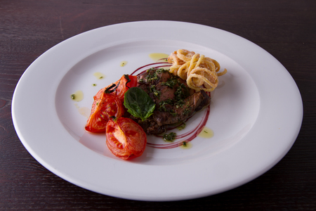 sliced beef served with home made pasta and tomatoの写真素材