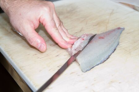 cook preparing salmon to be cooked