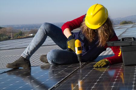 young skilled girl fitting a photovoltaic plant