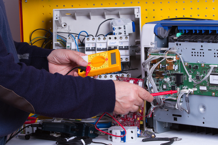 electrician fixing electrical deviceのeditorial素材