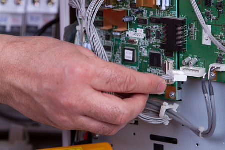 electrician fixing electrical deviceのeditorial素材