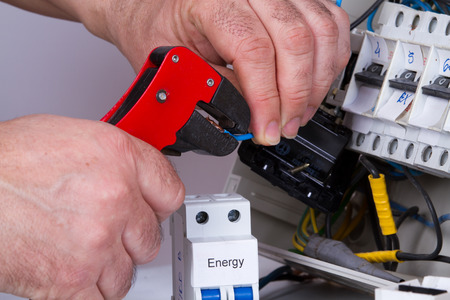 electrician fixing  electrical devices with different toolsの写真素材