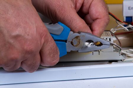electrician fixing  electrical devices with different toolsの写真素材