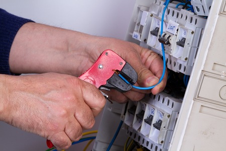 electrician fixing  electrical devices with different toolsの写真素材