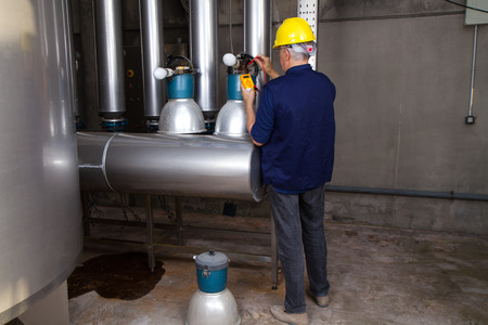 electrician repairing street lamps in a industrial site