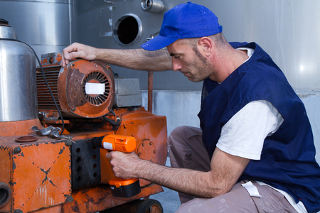 repairman at work during maintenance workの写真素材