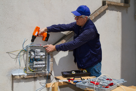 electrician at work with an electric panel