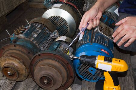 repairman during maintenance work of electric motorsの写真素材