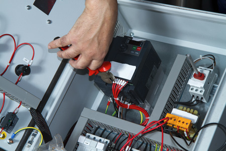 technician at maintenance work with an electric pump