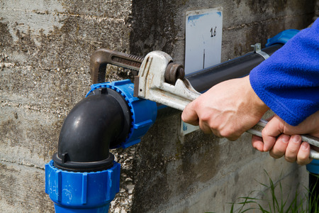 plumber at work in wastewater treatment plant