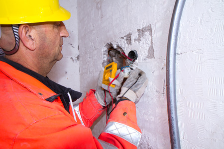 electrician at work with a plug
