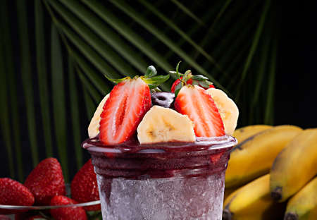 Acai cup with strawberry and banana toppingの写真素材