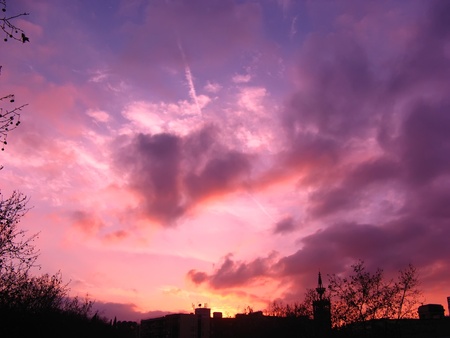 Vibrant and colorful purple sunset with silhouette of mountainの写真素材