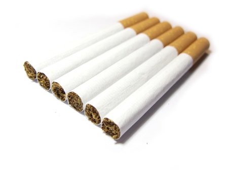 Aligned cigarettes isolated in whiteの写真素材