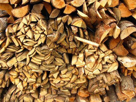 Piled firewood, wood texture close up