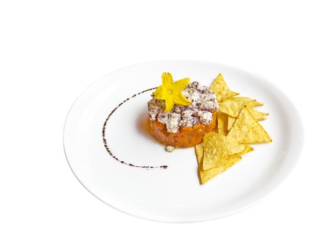 Fresh cheese and carrot tartare, with some nachos (tortilla chips)の写真素材