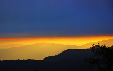 Golden sunset over mountain silhouette (Spain)