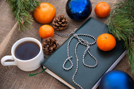Christmas decorations business notebook, coffee Cup and tangerines. Business Christmas set. The view...