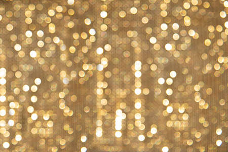 Abstract Christmas blurry background of glowing Golden lightsの写真素材