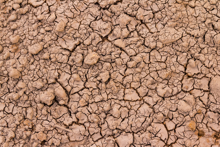 Cracked clay ground into the dry seasonの写真素材