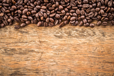 Coffee beans on old woodの写真素材