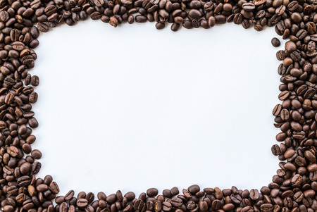 Frame arranged with coffee beans on white backgroundの写真素材