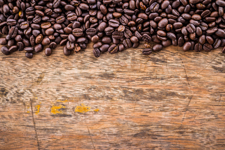 Coffee beans on old wood backgroundの写真素材