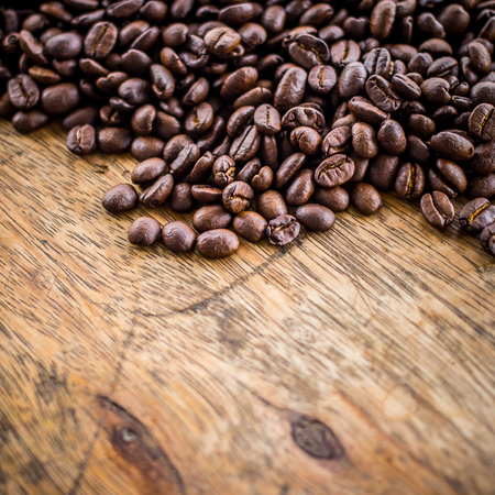Coffee beans on old wood backgroundの写真素材