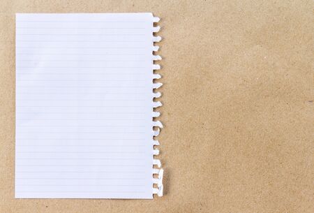 Note paper on brown paper backgroundの写真素材