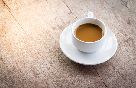 Cup of coffee on a wooden deskの写真素材