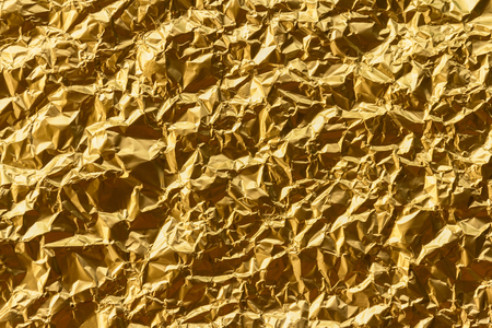 Crumpled gold foil texture backgroundの写真素材