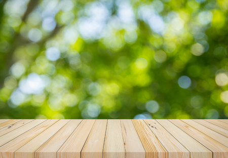 Wood plank with abstract natural green blurred bokeh background for product displayの写真素材