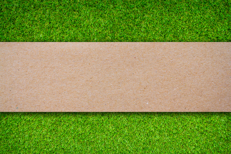 Grass background with blank brown paper labelの写真素材